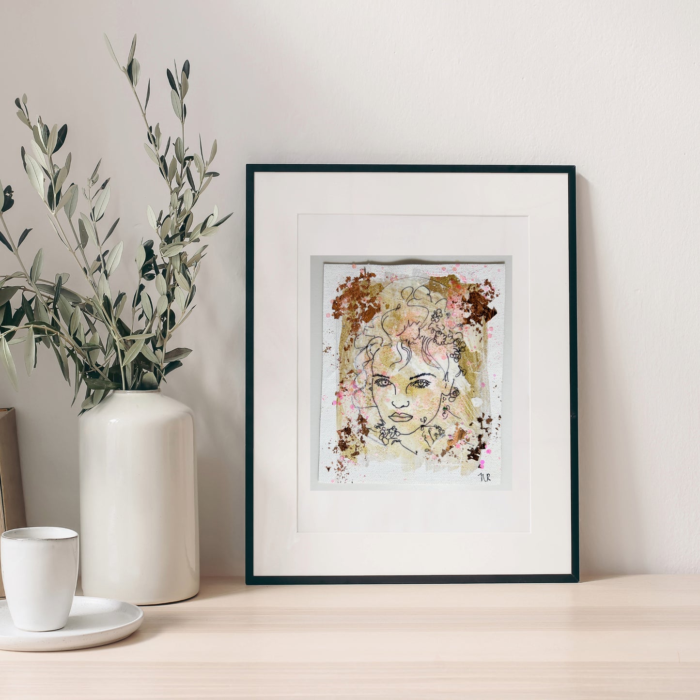 5x6 inch painting by Natalie Russo, featuring a black line drawing of a goddess with copper and gold accents, framed and displayed on a minimalist tabletop.