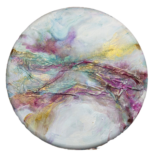Textured round abstract painting titled 'Celestial Hues' by Natalie Russo, featuring rich violet, gold, and soft blue tones with fabric texture. The 24-inch diameter artwork is created with acrylic paint and gold mica powder, offering a cosmic and elegant visual experience.